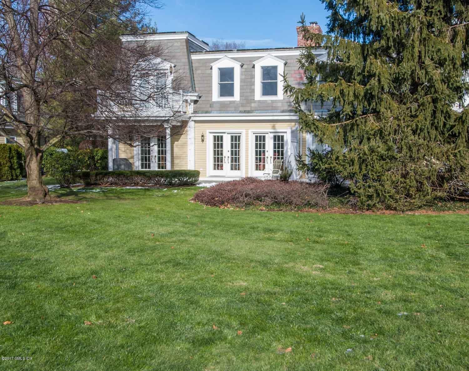 4 Old Church Road, Unit 6 Greenwich, CT 06830 - Photo 17 of 19 a front view of a house with a garden