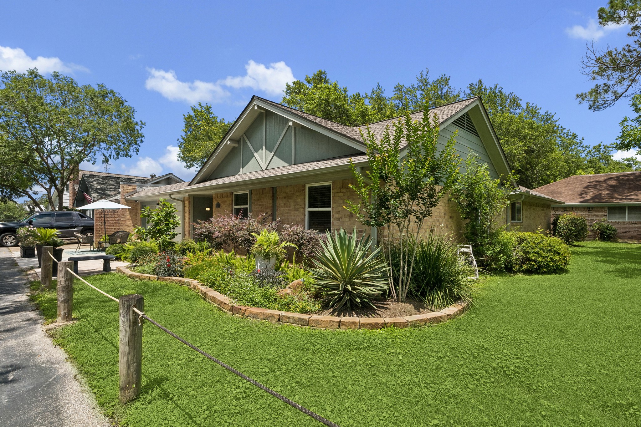 2102 Casa Rio Circle Dickinson, TX 77539 - Photo 2 of 22 Lush gardens, mature shade trees, and a highly desirable location set this home apart. With no neighboring residence directly to the right or behind, this beautifully updated single story condominium offers a rare sense of openness and privacy within one of Dickinson's most charming waterfront communities. ***Bonus 14 Seer HVAC & Energy Efficient Hot Water Heater ~ Both approximately 6yrs old ~ Professionally Landscaped & Hardscaped Front Yard ~ French Drains***