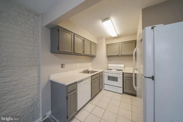 a kitchen with a stove sink and refrigerator