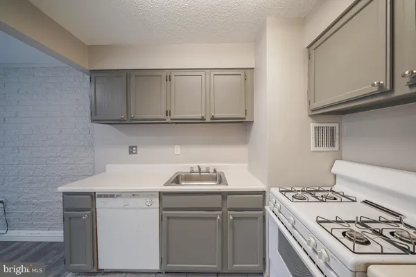 a kitchen with a stove and a sink