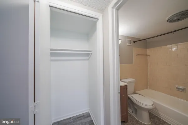 a white toilet sitting next to a bathroom sink and vanity