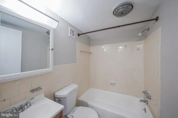 a bathroom with a toilet and a bathtub