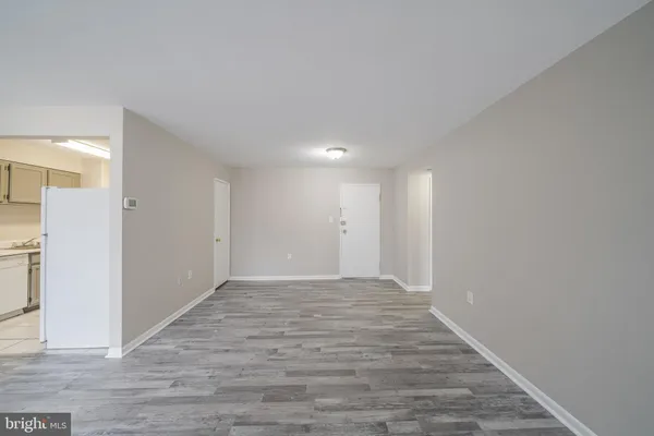 a view of an empty room and wooden floor