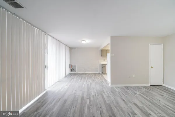 a view of a room with wooden floor