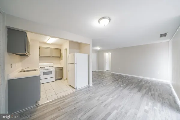 a kitchen with stainless steel appliances a refrigerator and a stove top oven