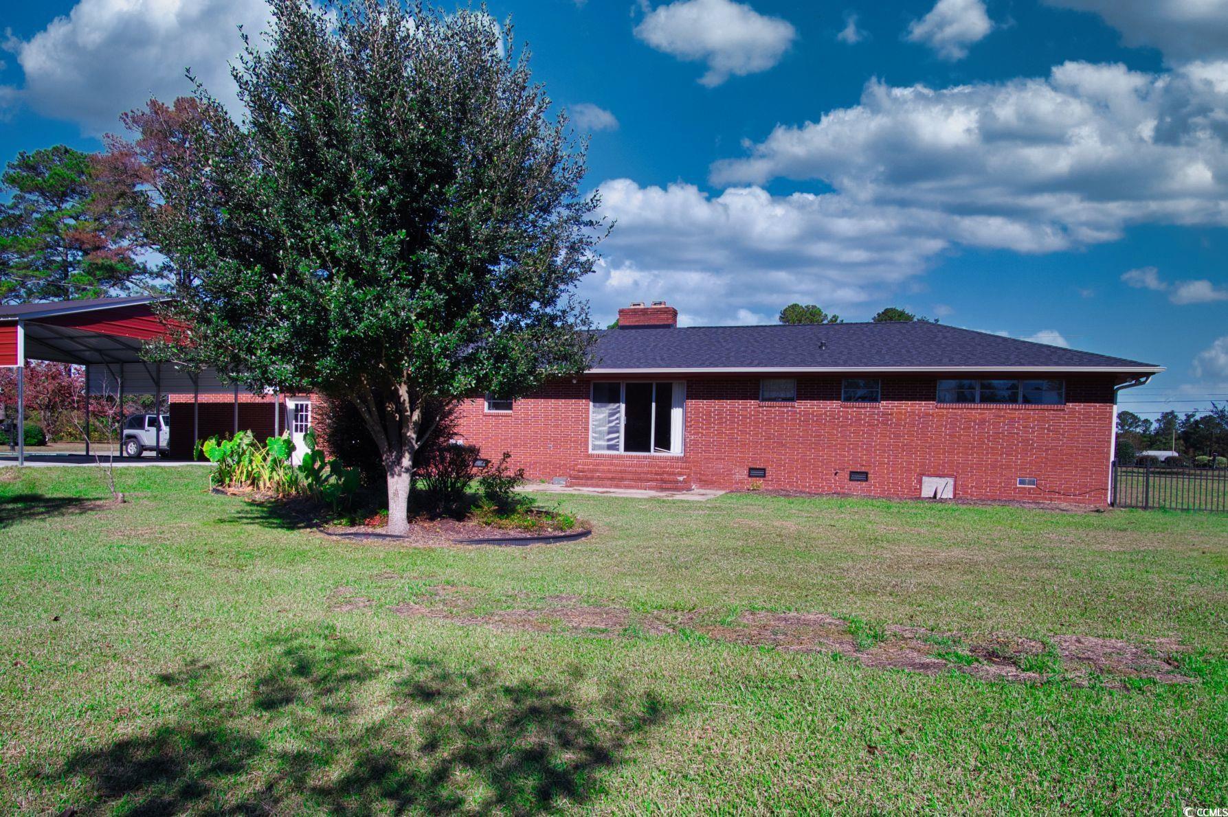 5408 Main Street Loris, SC 29569 - Photo 2 of 20 Rear view of property featuring a lawn, crawl space, brick siding, and a chimney