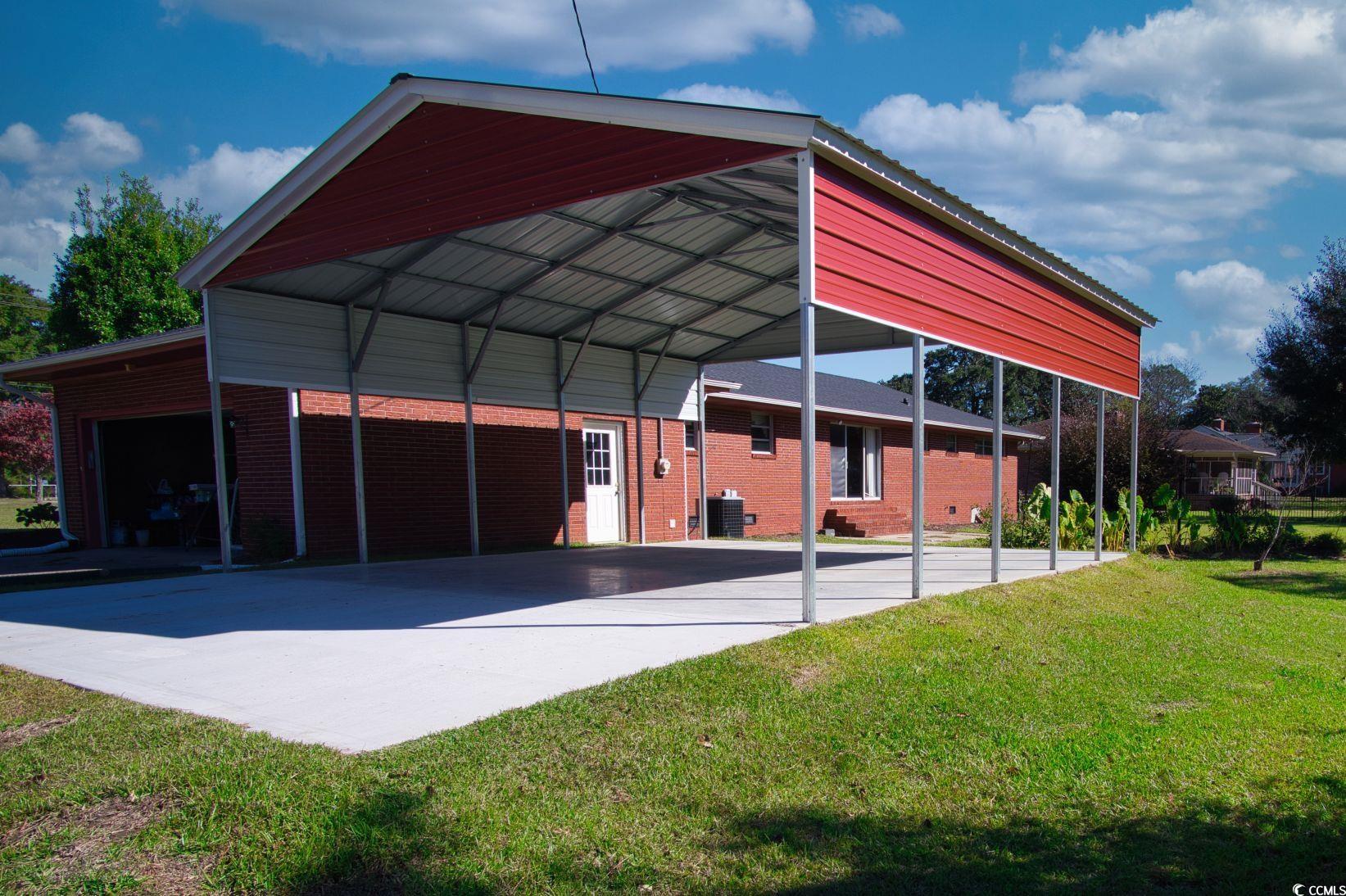 5408 Main Street Loris, SC 29569 - Photo 3 of 20 View of outbuilding featuring a garage and a carport