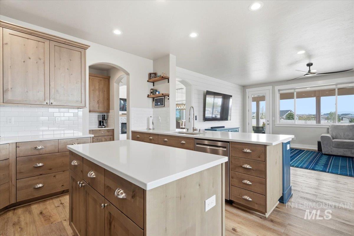 1282 Cimarron Court Middleton, ID 83644 - Photo 44 of 44 Kitchen with a peninsula, open floor plan, light wood-style floors, a center island, and backsplash
