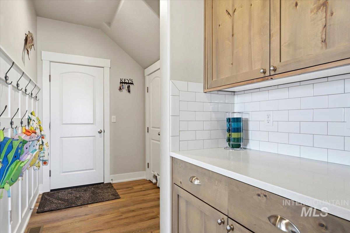 1282 Cimarron Court Middleton, ID 83644 - Photo 16 of 44 Laundry room featuring dark wood-type flooring and lofted ceiling