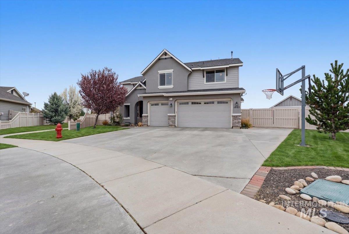 1282 Cimarron Court Middleton, ID 83644 - Photo 2 of 44 View of front of home with a garage, driveway, stone siding, and stucco siding