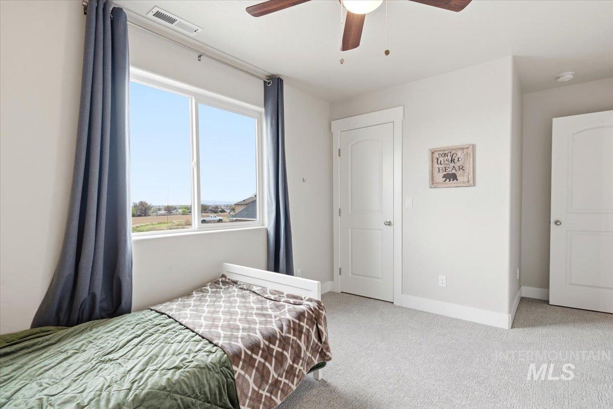 1282 Cimarron Court Middleton, ID 83644 - Photo 21 of 44 Bedroom with light carpet and a ceiling fan