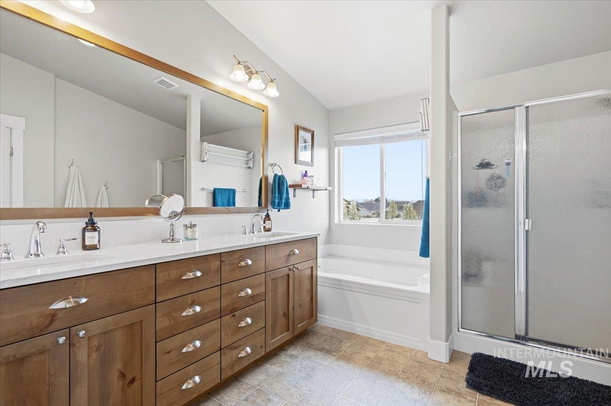 1282 Cimarron Court Middleton, ID 83644 - Photo 25 of 44 Bathroom featuring double vanity, a stall shower, and a garden tub
