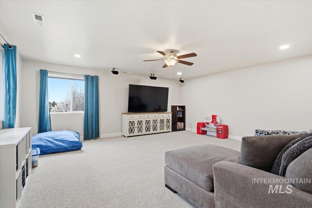 1282 Cimarron Court Middleton, ID 83644 - Photo 27 of 44 Carpeted living area featuring a ceiling fan and recessed lighting
