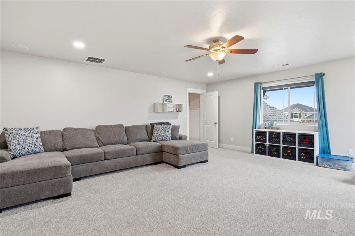 1282 Cimarron Court Middleton, ID 83644 - Photo 28 of 44 Living room featuring ceiling fan, carpet flooring, and recessed lighting