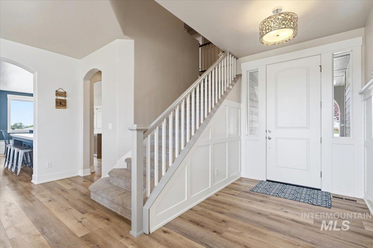 1282 Cimarron Court Middleton, ID 83644 - Photo 3 of 44 Entryway with light wood-type flooring, arched walkways, and a decorative wall