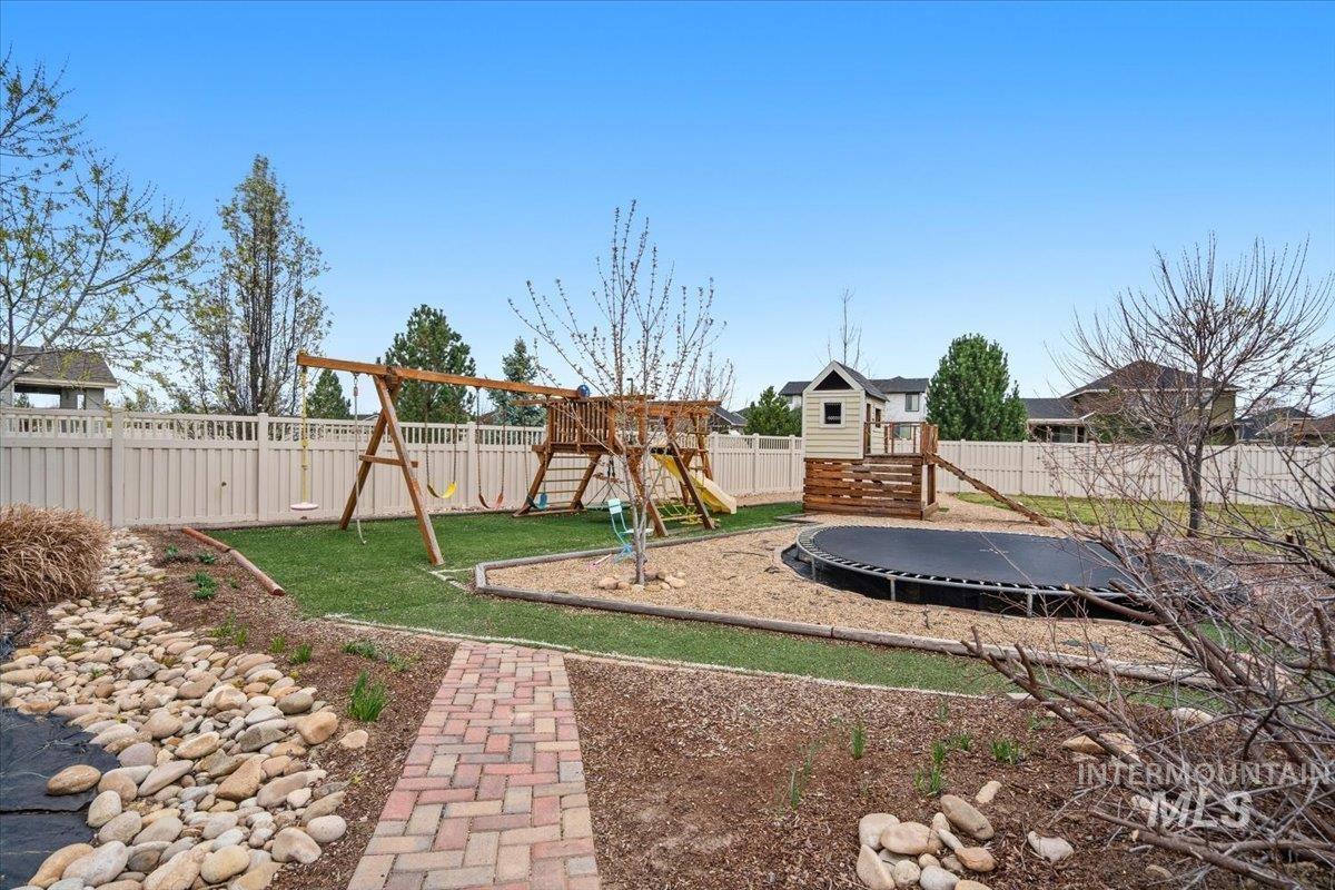 1282 Cimarron Court Middleton, ID 83644 - Photo 32 of 44 Fenced backyard with a trampoline and a playground