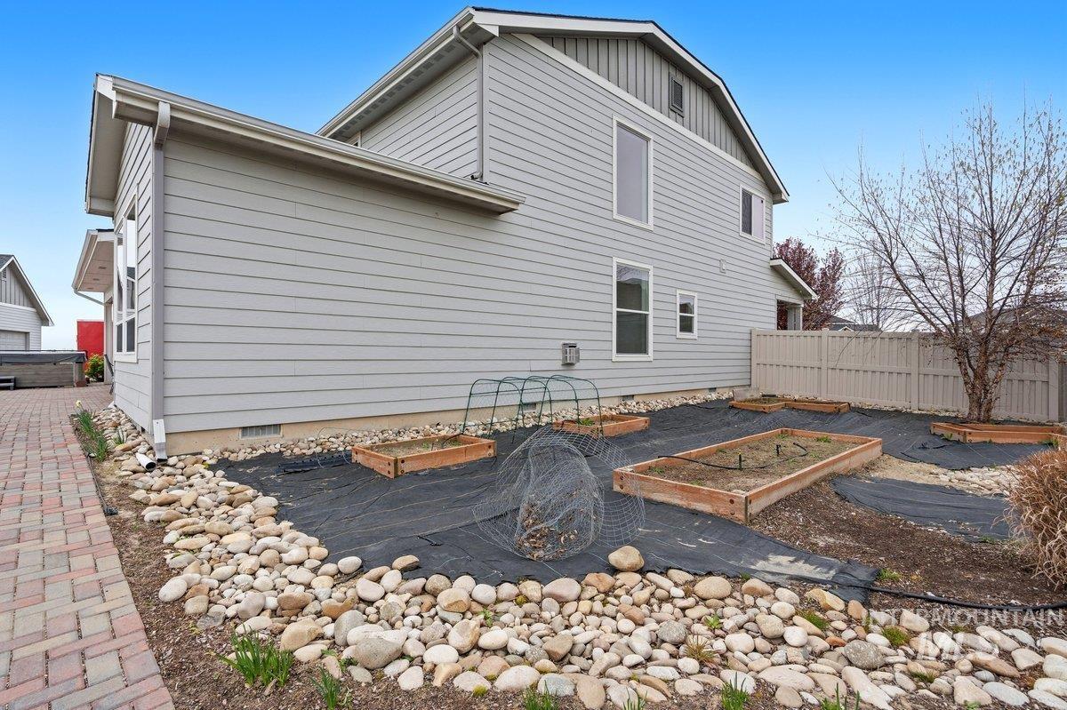 1282 Cimarron Court Middleton, ID 83644 - Photo 40 of 44 Back of property with a vegetable garden, crawl space, board and batten siding, and a deck