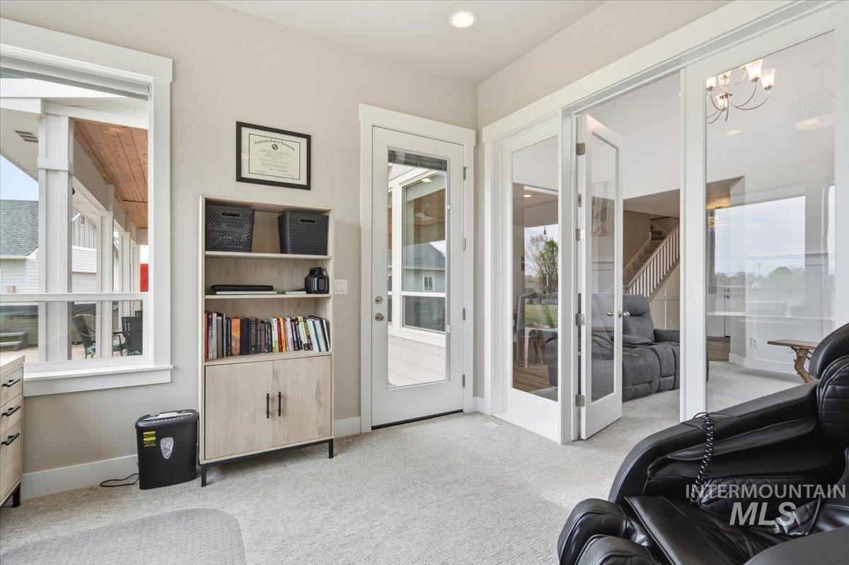 1282 Cimarron Court Middleton, ID 83644 - Photo 7 of 44 Sitting room with light colored carpet, plenty of natural light, and hanging lights
