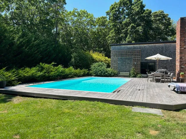 a view of a backyard with sitting area