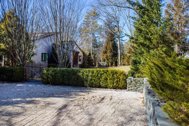 a view of a pathway both side of house