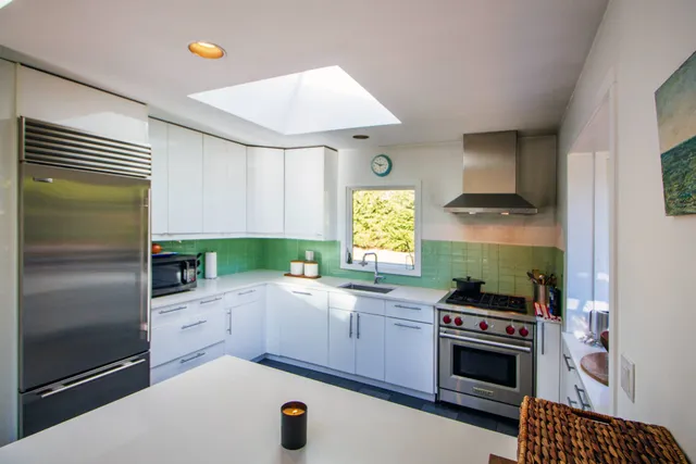 a kitchen with a sink appliances and cabinets