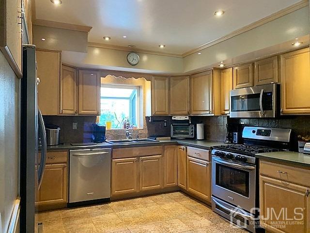 730 Center Street Dunellen, NJ 08812 - Photo 9 of 27 a kitchen with stainless steel appliances granite countertop a sink a stove a refrigerator cabinets and a window