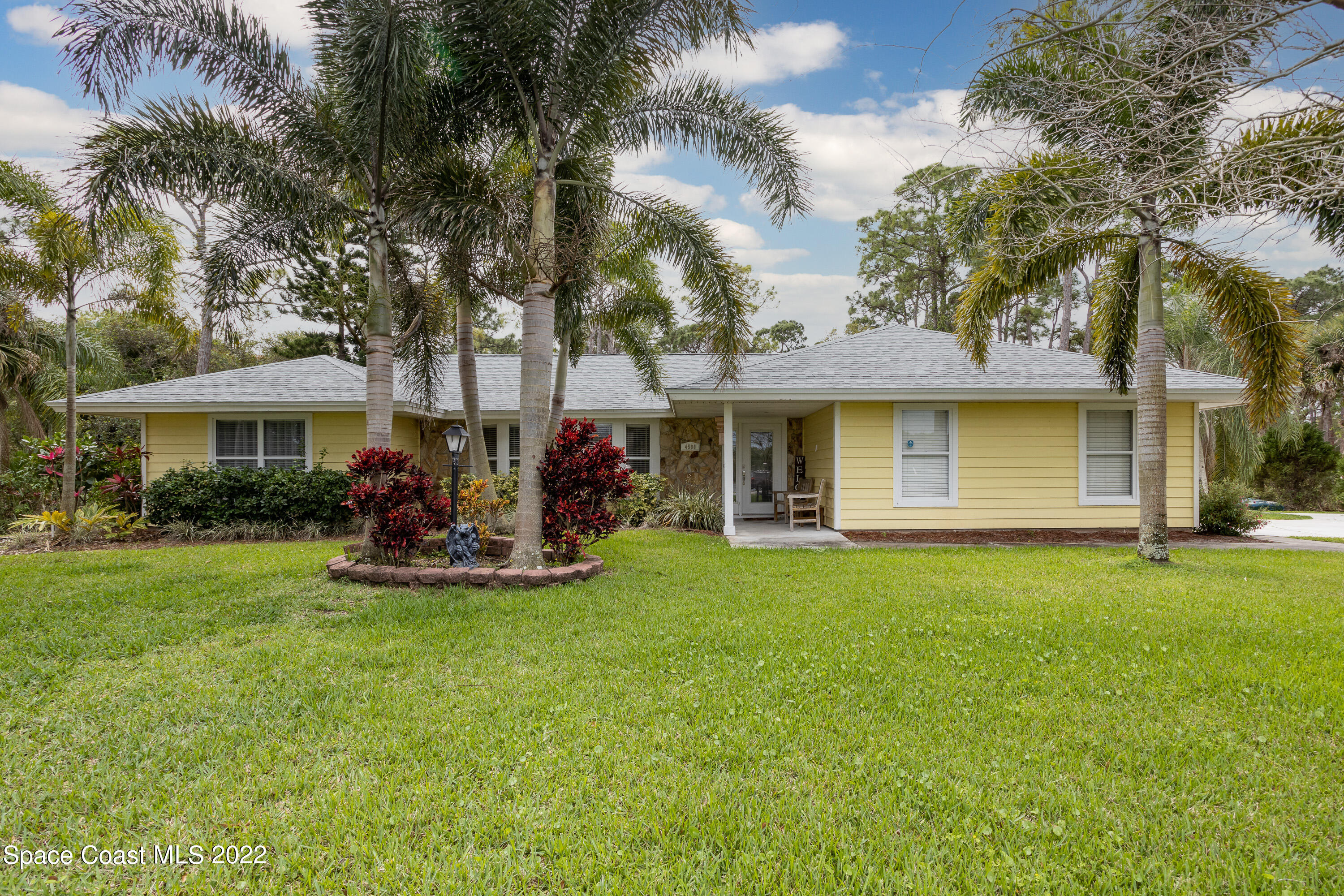 4500 Hunters Run Circle Grant Valkaria, FL 32949 - Photo 3 of 35 a view of a house with a yard and sitting area