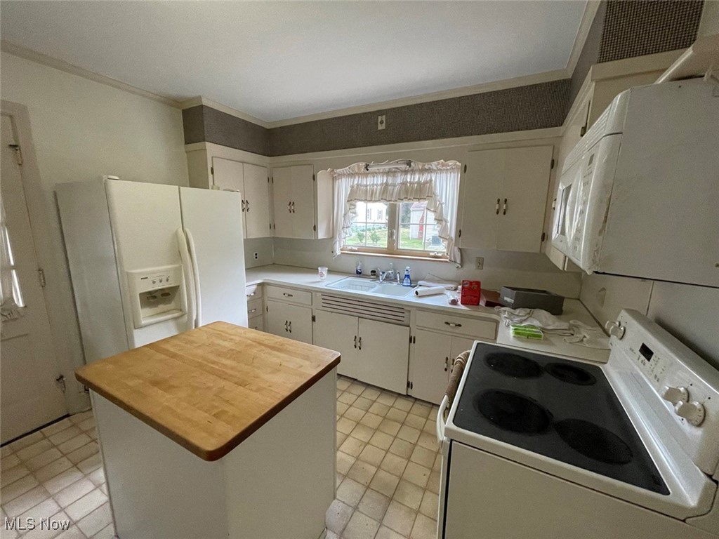 2702 Martin Road Zanesville, OH 43701 - Photo 17 of 34 Kitchen with a center island, white appliances, white cabinetry, sink, and ornamental molding