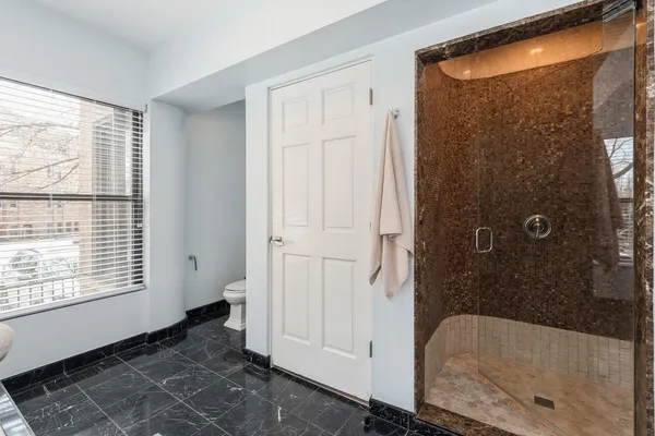 a bathroom with a bathtub and shower