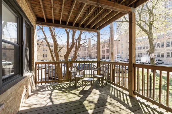 a view of a balcony with wooden floor