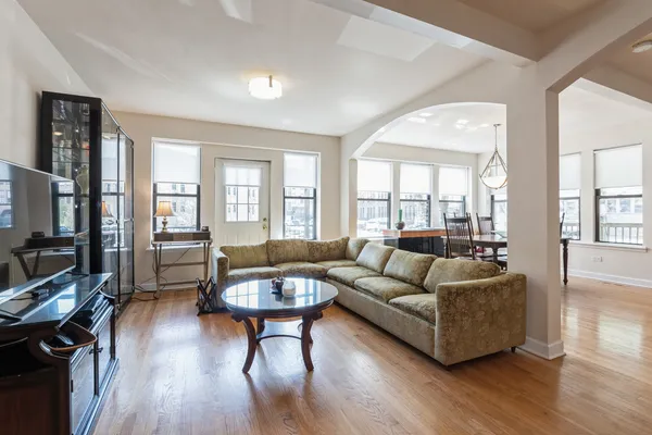 a living room with fireplace furniture and a wooden floor