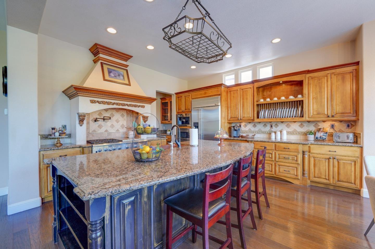 2400 Club Drive Gilroy, CA 95020 - Photo 20 of 67 a kitchen with granite countertop kitchen island a table and chairs in it