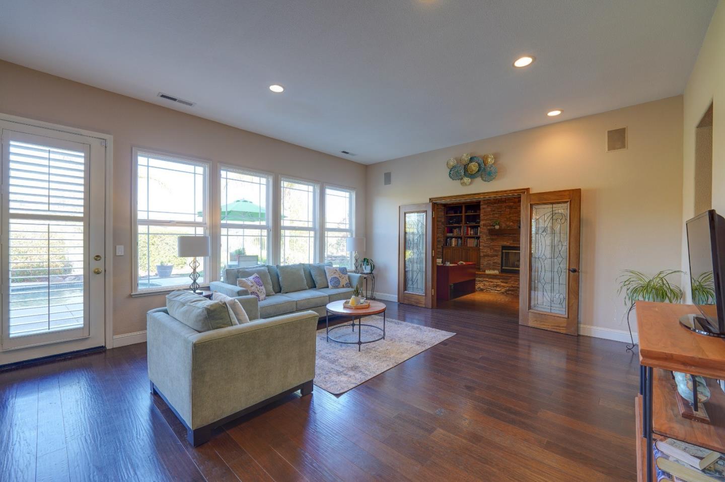 2400 Club Drive Gilroy, CA 95020 - Photo 23 of 67 a living room with fireplace furniture and a wooden floor