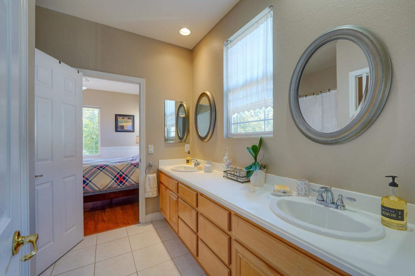 2400 Club Drive Gilroy, CA 95020 - Photo 37 of 67 a en suite bathroom with a granite countertop tub and a sink