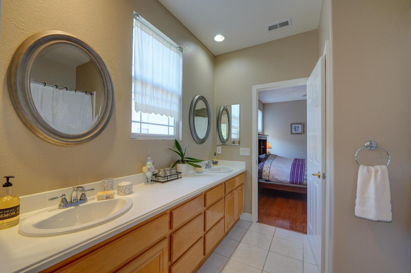 2400 Club Drive Gilroy, CA 95020 - Photo 38 of 67 a en suite bathroom with a granite countertop double vanity and a mirror