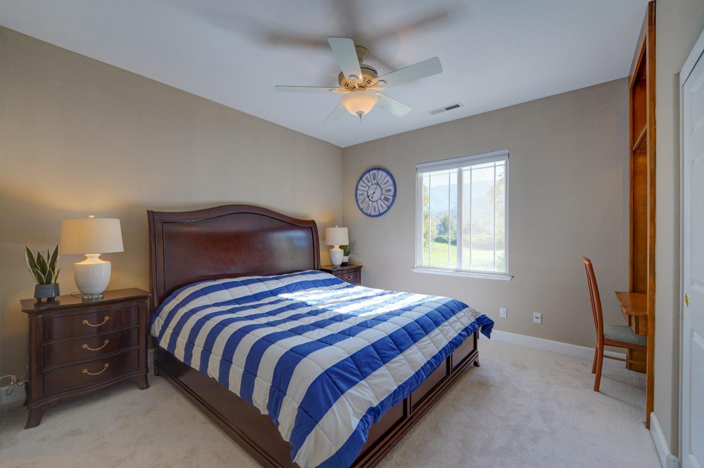 2400 Club Drive Gilroy, CA 95020 - Photo 41 of 67 a bedroom with a bed and a chandelier