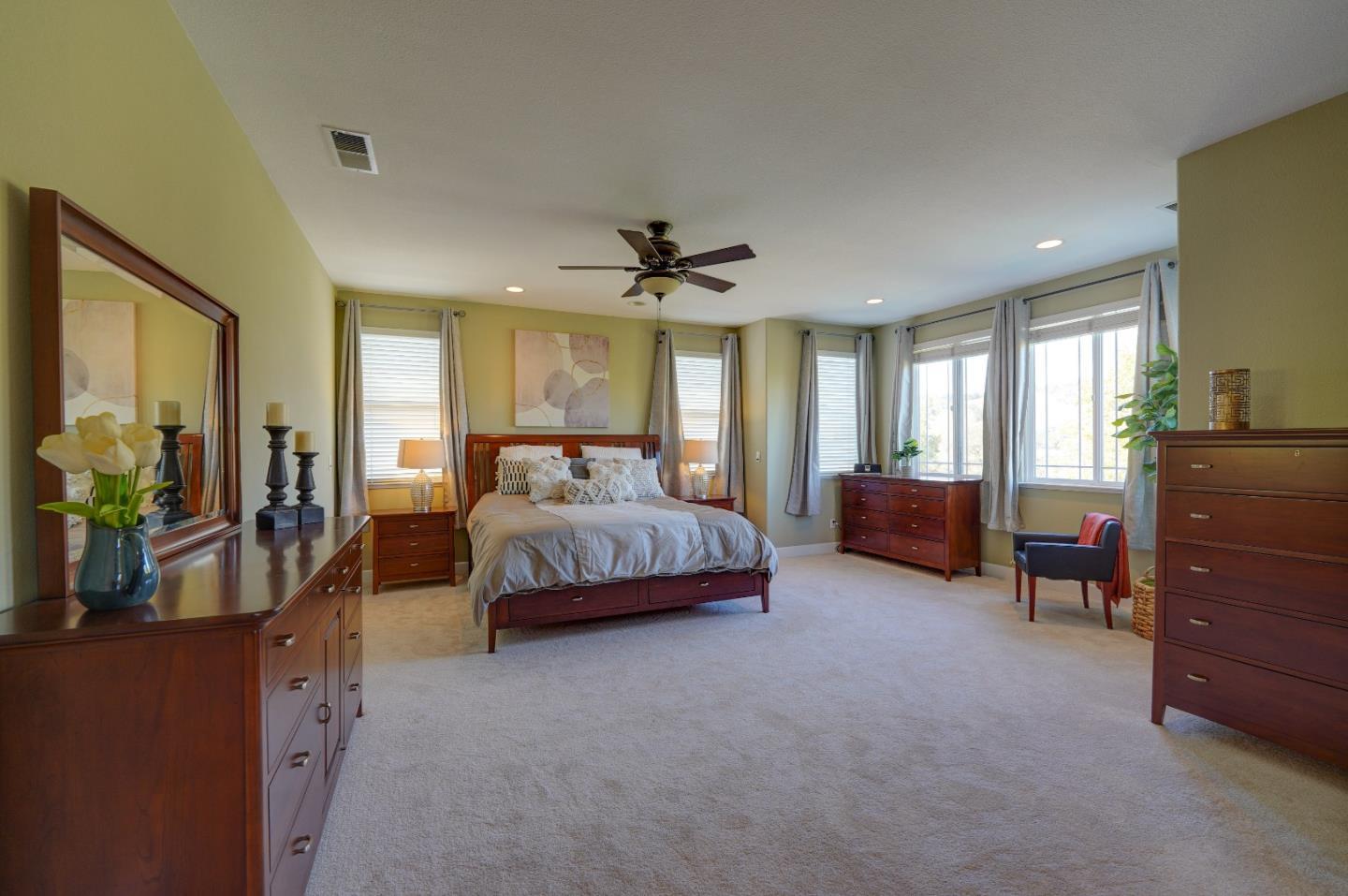 2400 Club Drive Gilroy, CA 95020 - Photo 47 of 67 a spacious bedroom with a bed and a chandelier