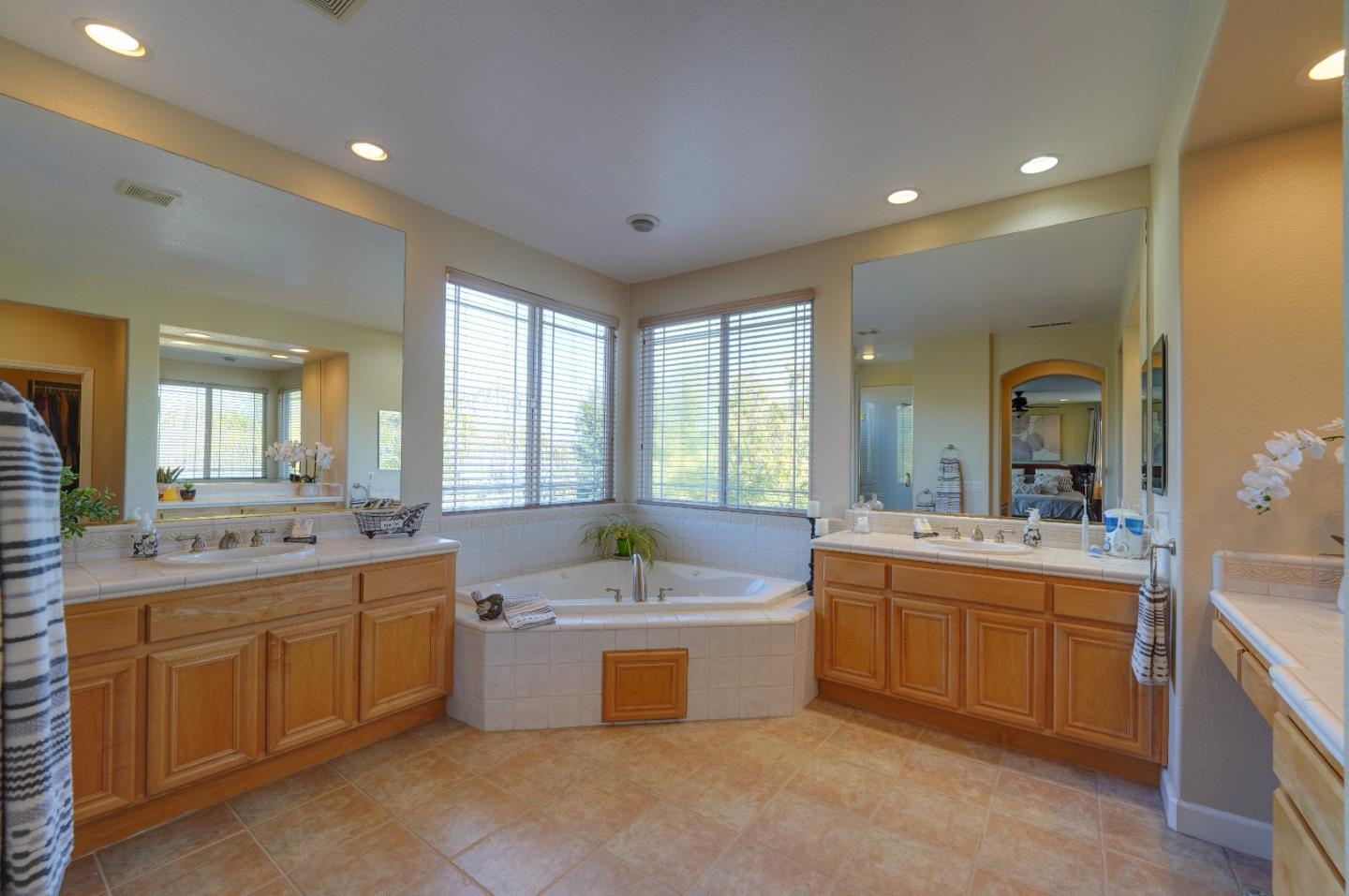 2400 Club Drive Gilroy, CA 95020 - Photo 50 of 67 a large bathroom with a double vanity sink a mirror and a bathtub