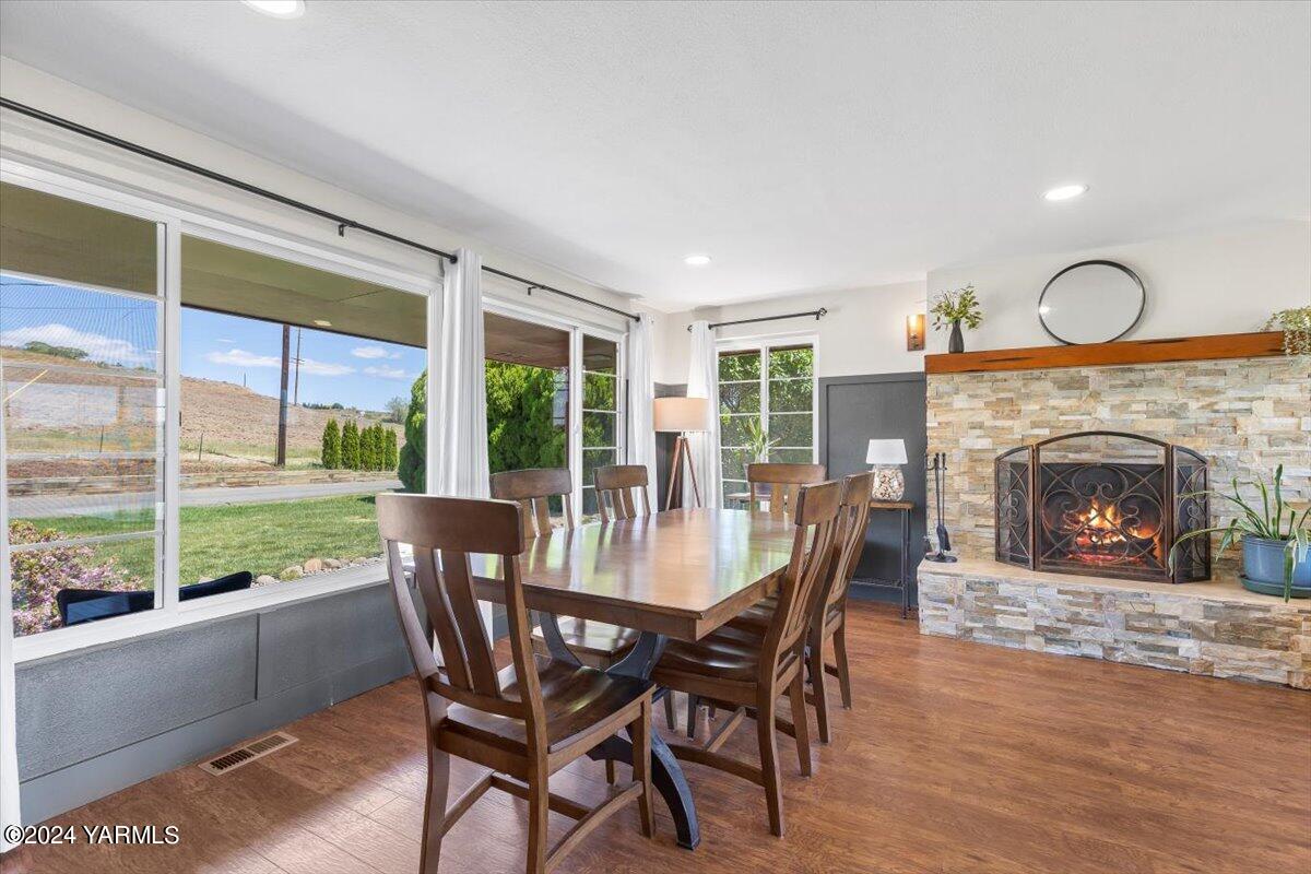 20 North Mize Road Yakima, WA 98908 - Photo 8 of 29 a dining room with furniture a fireplace and wooden floor