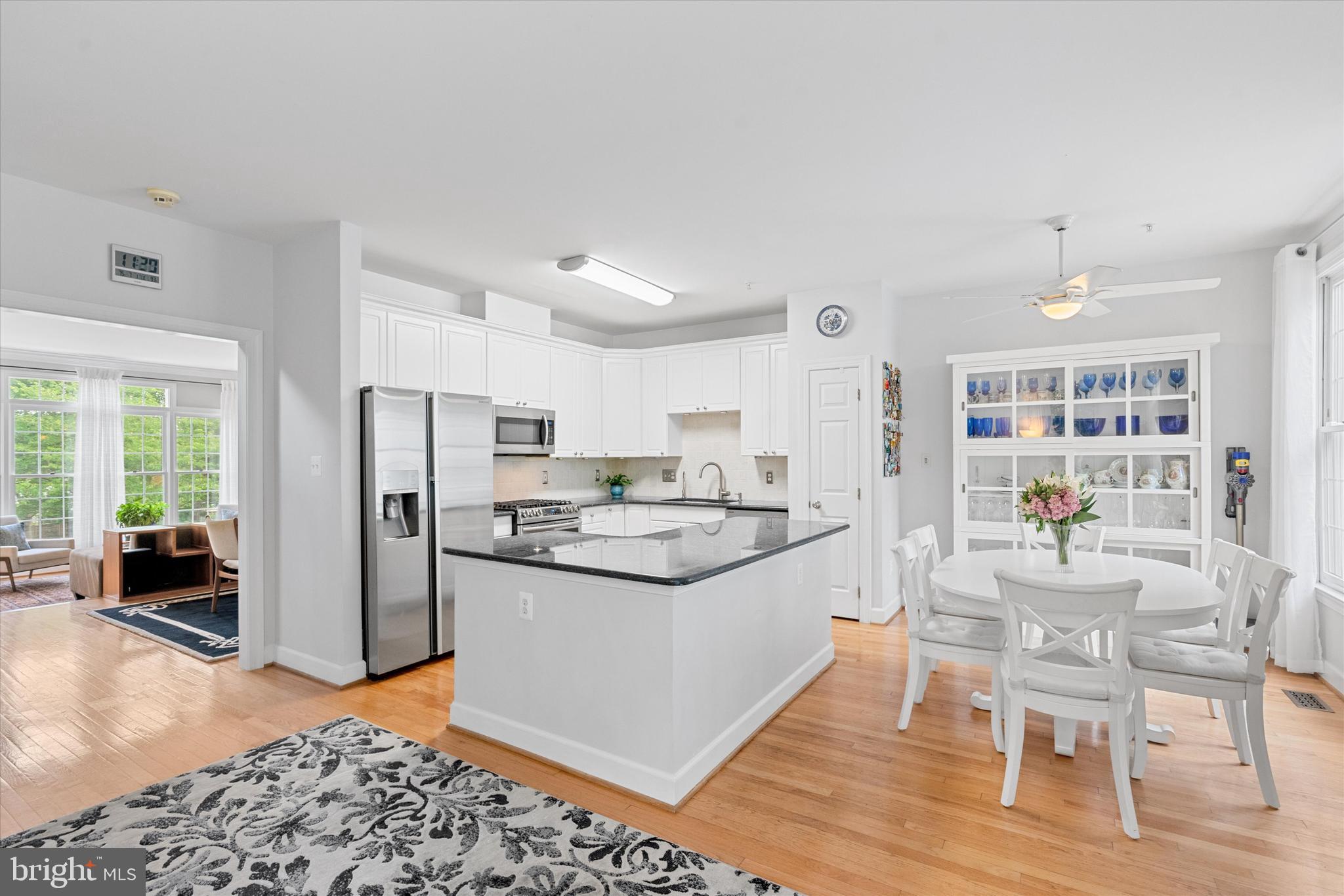 8512 Bells Ridge Terrace Potomac, MD 20854 - Photo 12 of 45 a kitchen with stainless steel appliances kitchen island granite countertop a refrigerator and a stove top oven