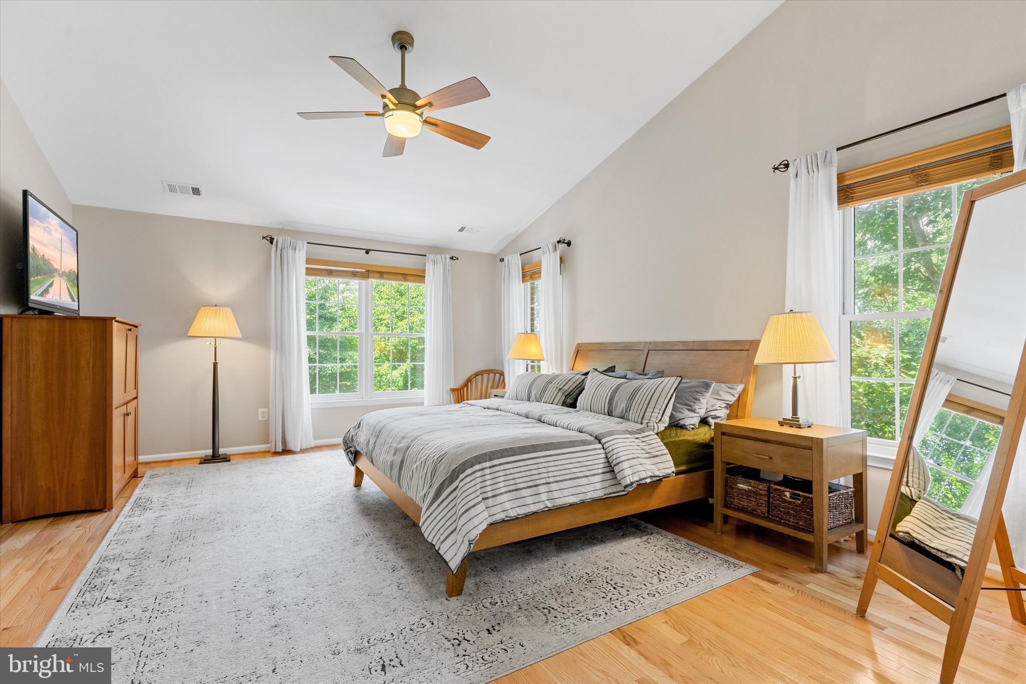 8512 Bells Ridge Terrace Potomac, MD 20854 - Photo 21 of 45 a bedroom with a bed a couch and a large window