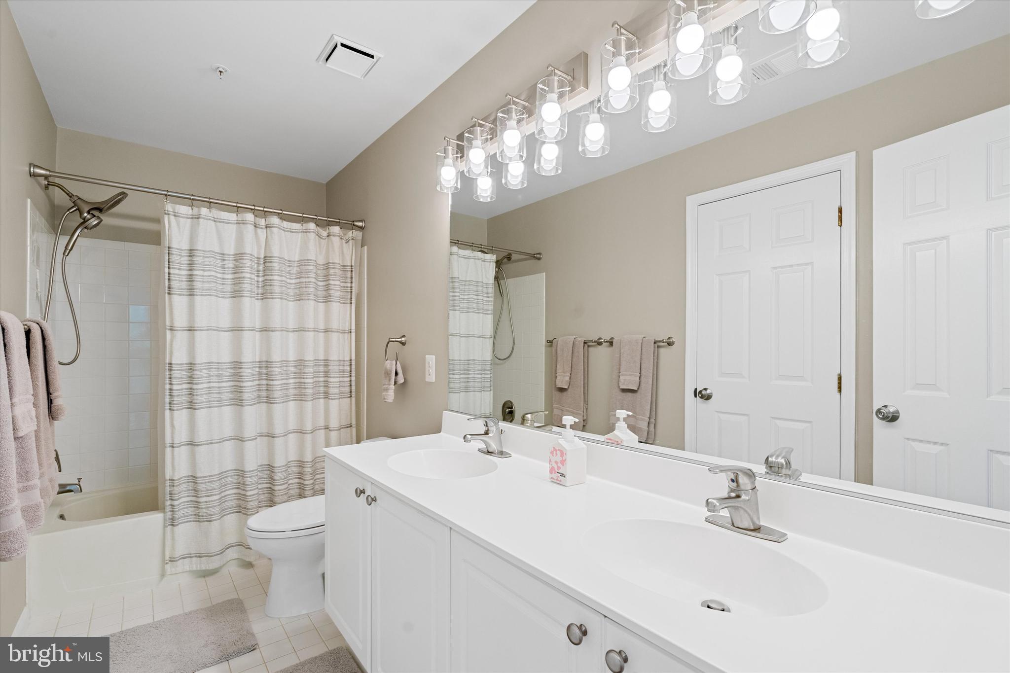 8512 Bells Ridge Terrace Potomac, MD 20854 - Photo 26 of 45 a bathroom with a sink a toilet and shower