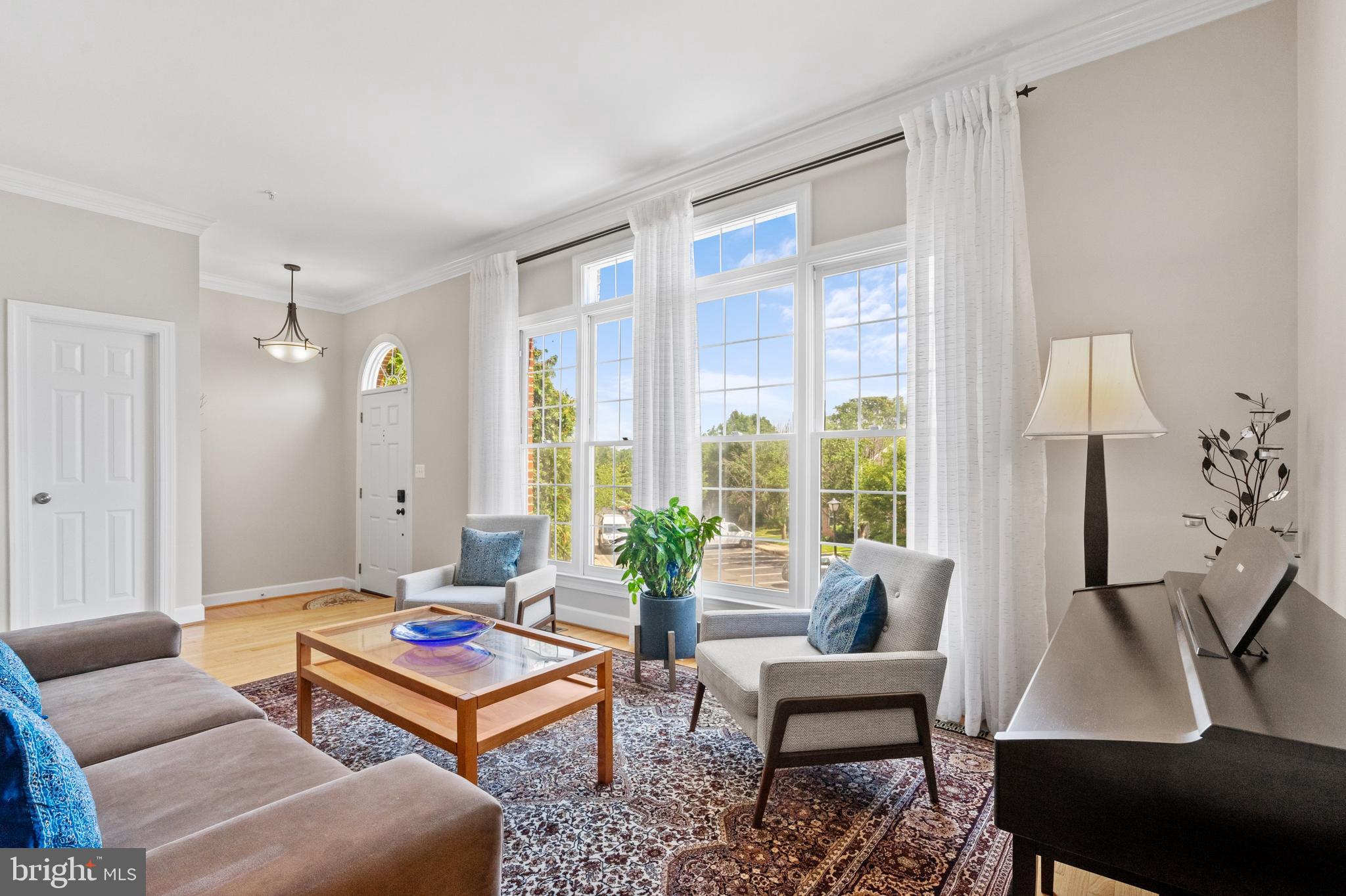 8512 Bells Ridge Terrace Potomac, MD 20854 - Photo 3 of 45 a living room with furniture a table and a large window