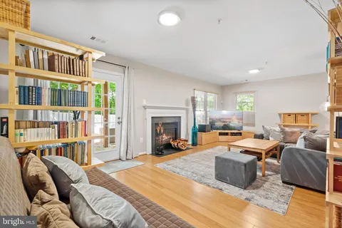 a living room with furniture and a book shelf