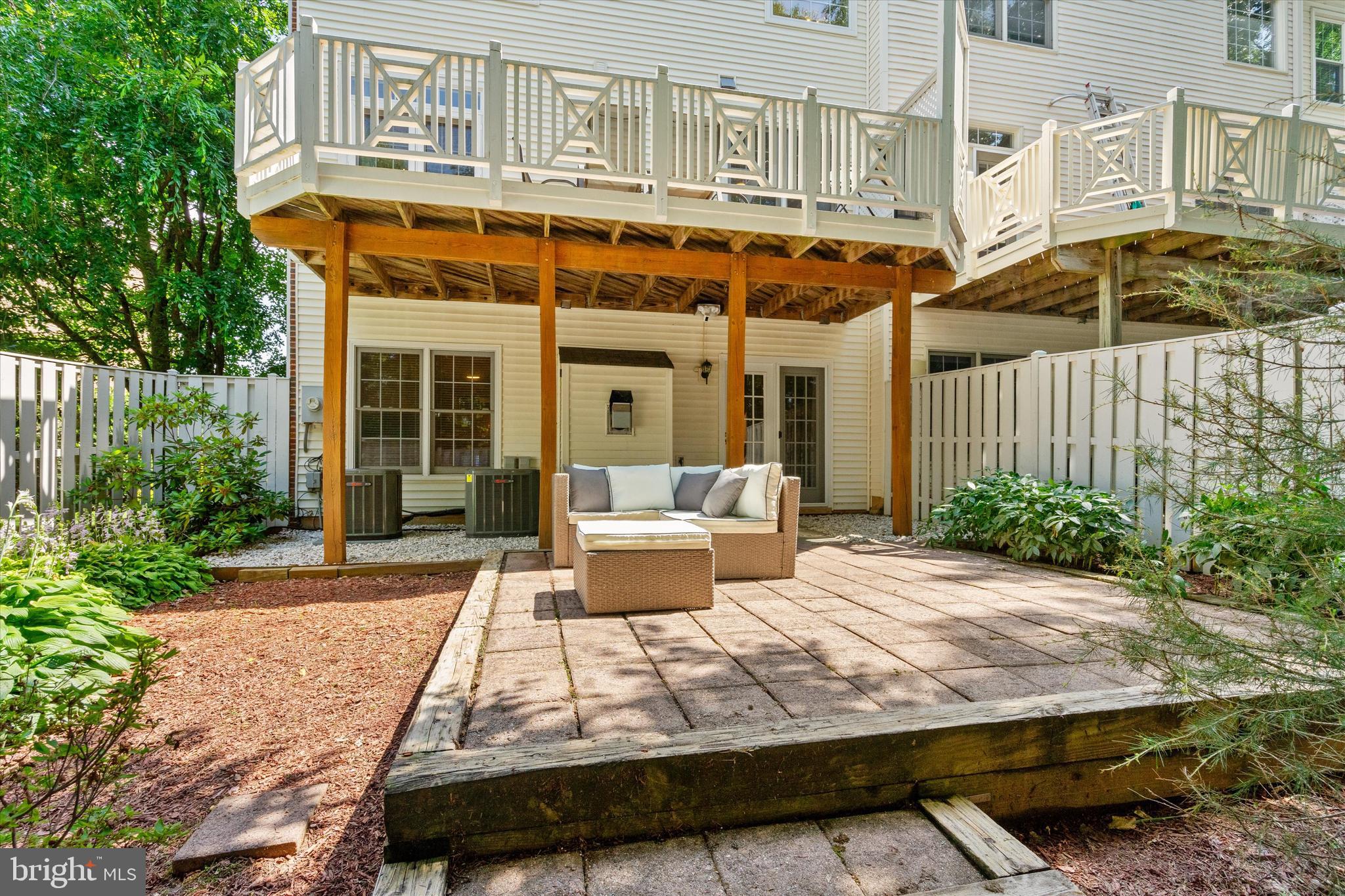 8512 Bells Ridge Terrace Potomac, MD 20854 - Photo 33 of 45 a view of a patio with couches table and chairs and potted plants