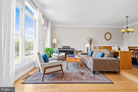 a living room with furniture and a piano