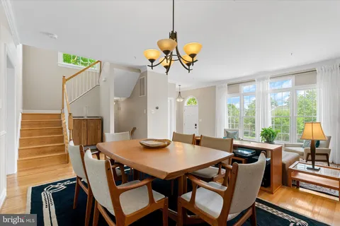 a dining room with furniture and a window