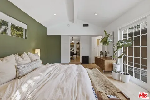 a spacious bedroom with a bed and a window