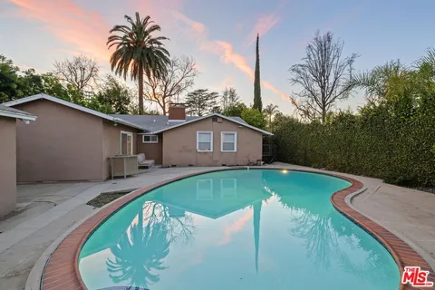 a swimming pool with a outdoor seating