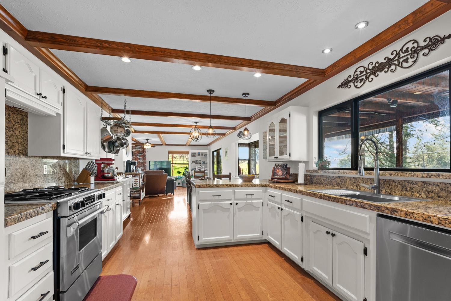 17476 Fiddletown Road Fiddletown, CA 95629 - Photo 19 of 82 a large white kitchen with stainless steel appliances granite countertop a lot of counter space and wooden floors